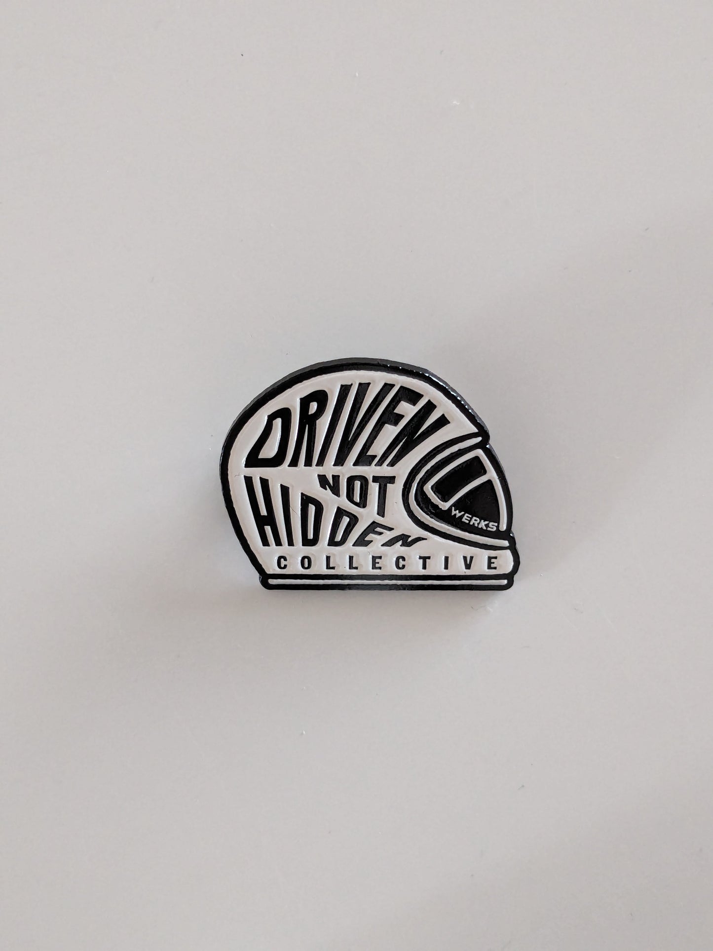 Driven Not Hidden Collective enamel pin badge