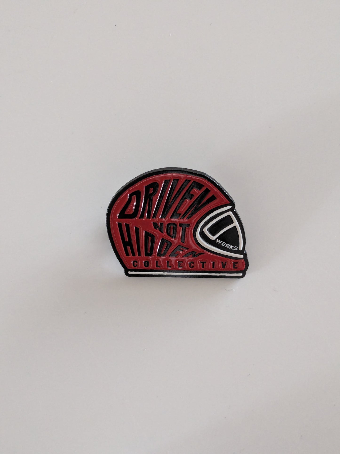 Driven Not Hidden Collective enamel pin badge