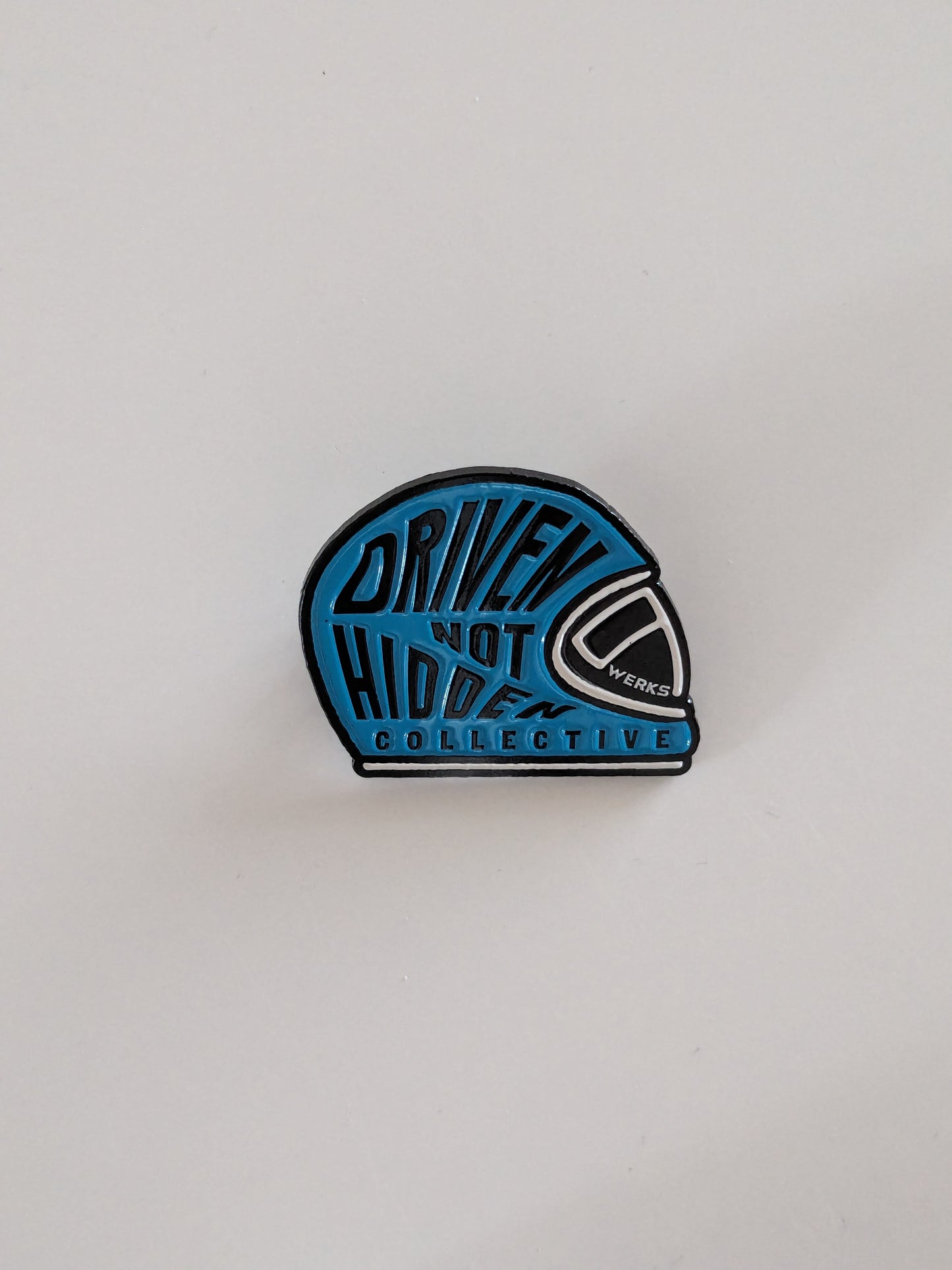 Driven Not Hidden Collective enamel pin badge