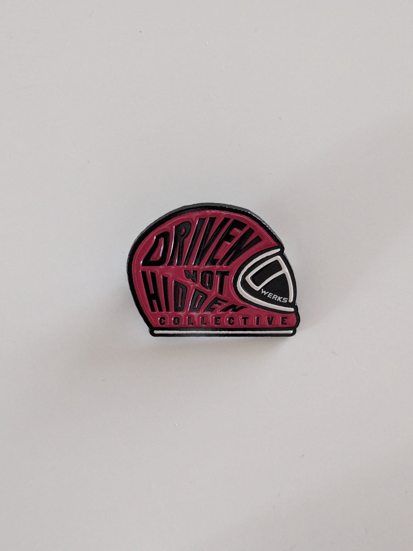 Driven Not Hidden Collective enamel pin badge