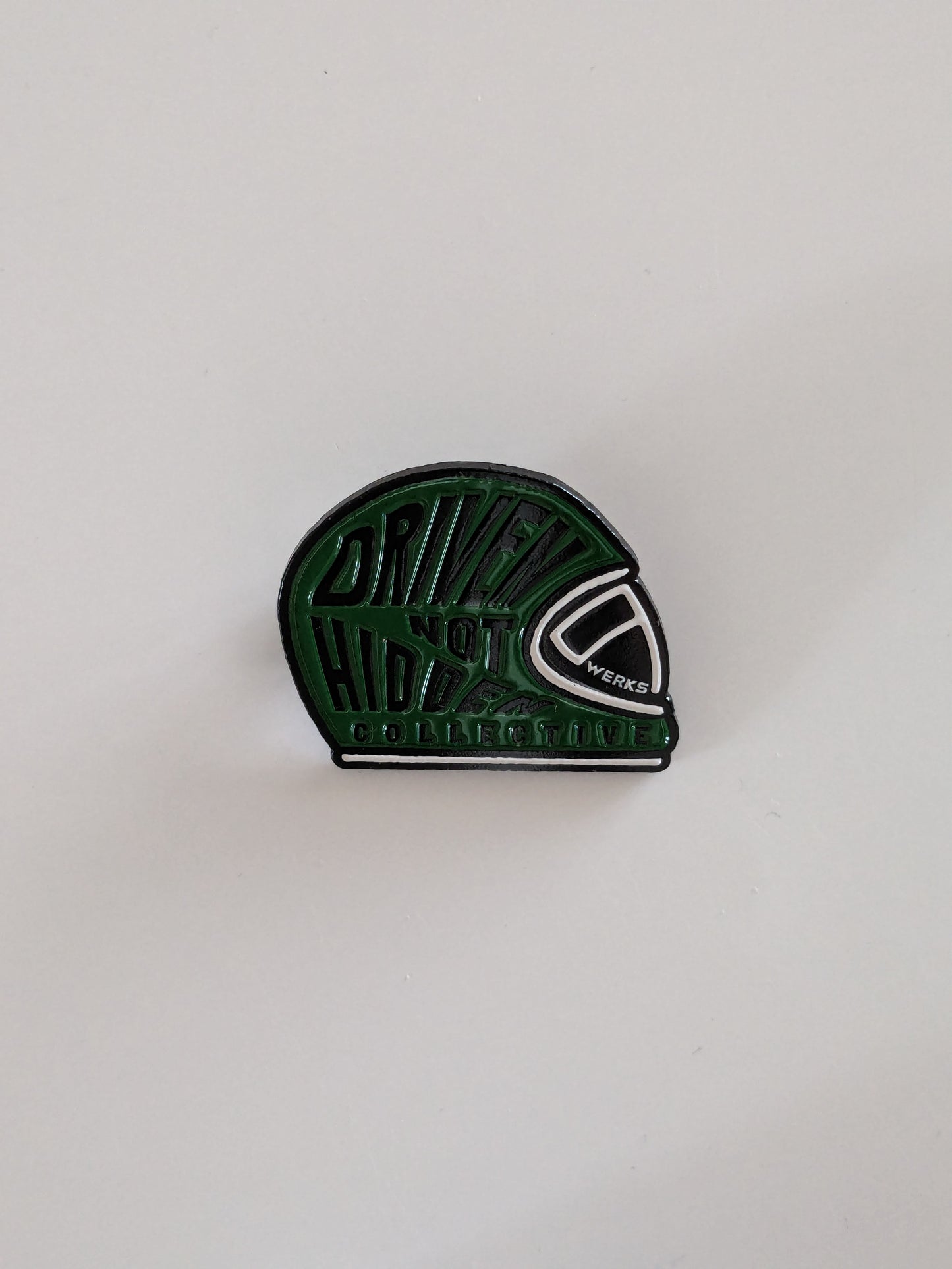 Driven Not Hidden Collective enamel pin badge