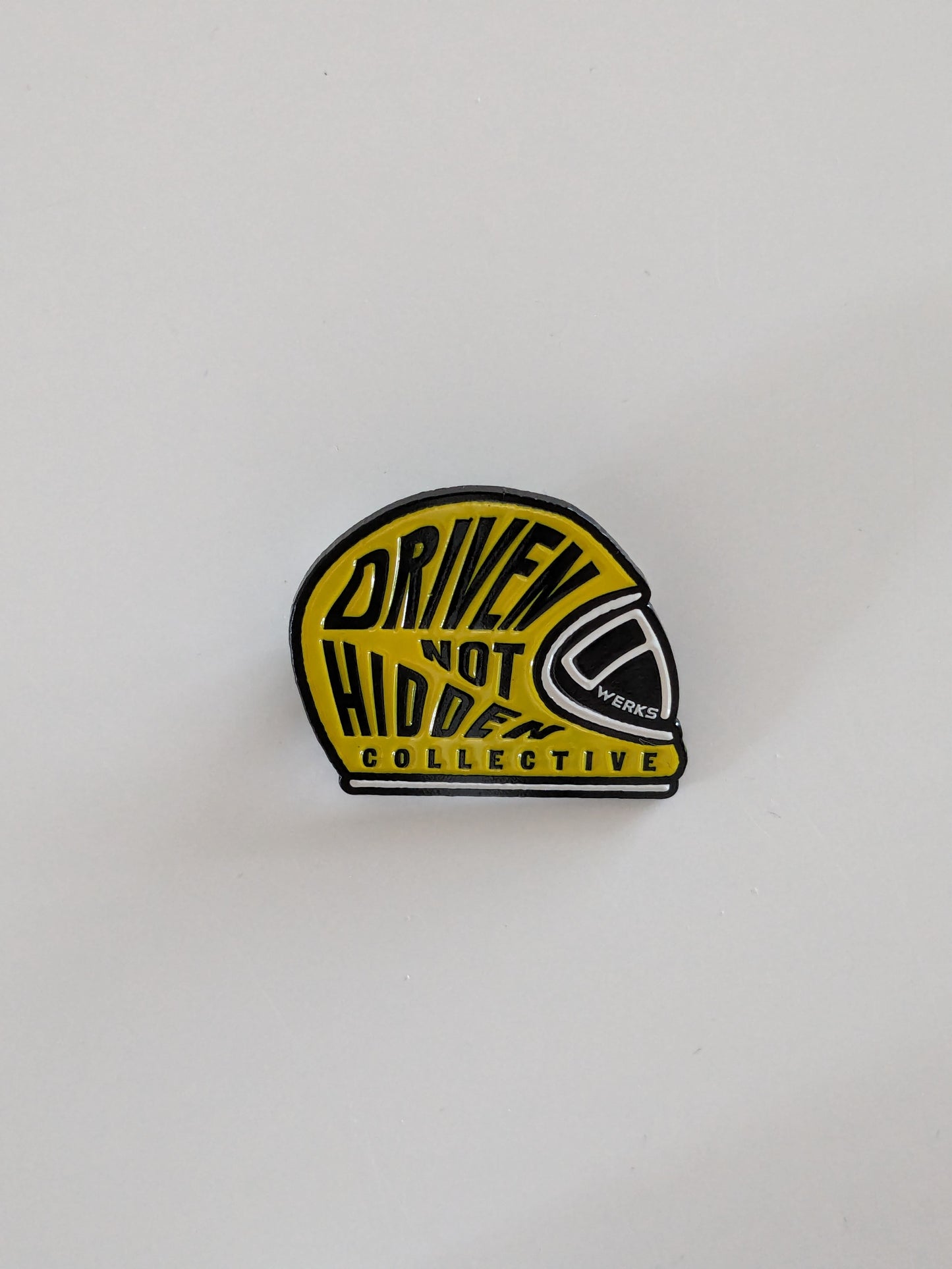 Driven Not Hidden Collective enamel pin badge